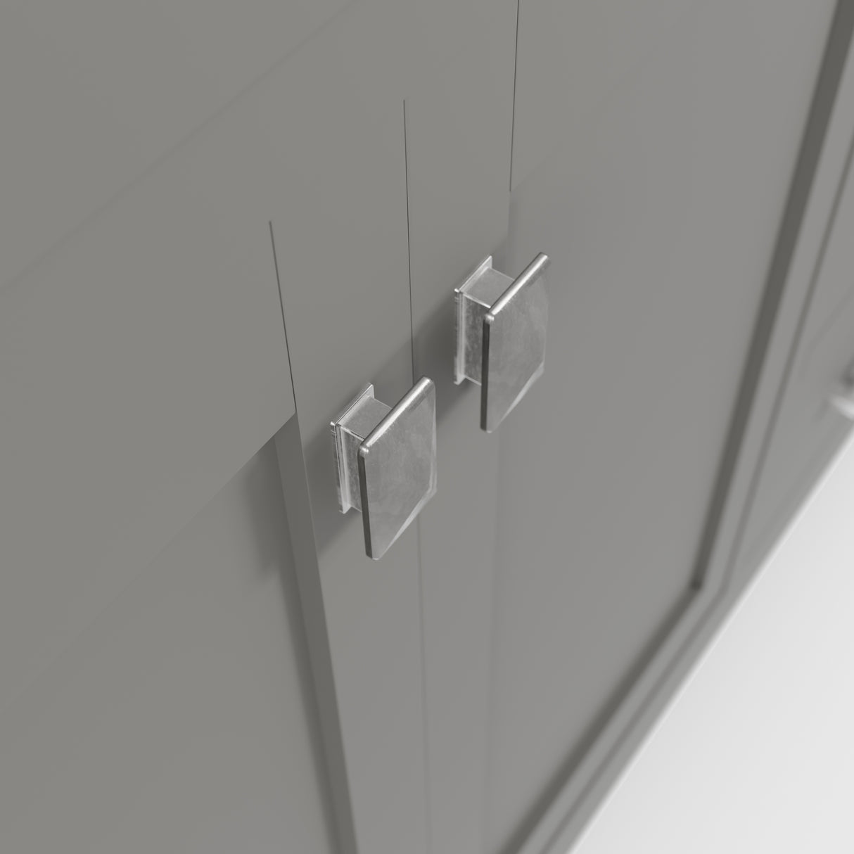 Close-up of a gray cabinet with metallic handles on a neutral background