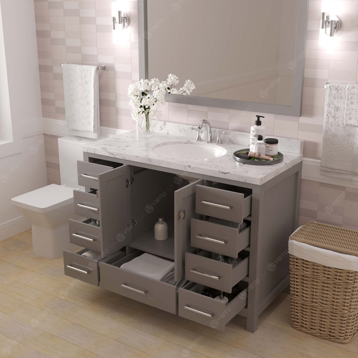 Bathroom vanity with open drawers, sink, and decorative items.