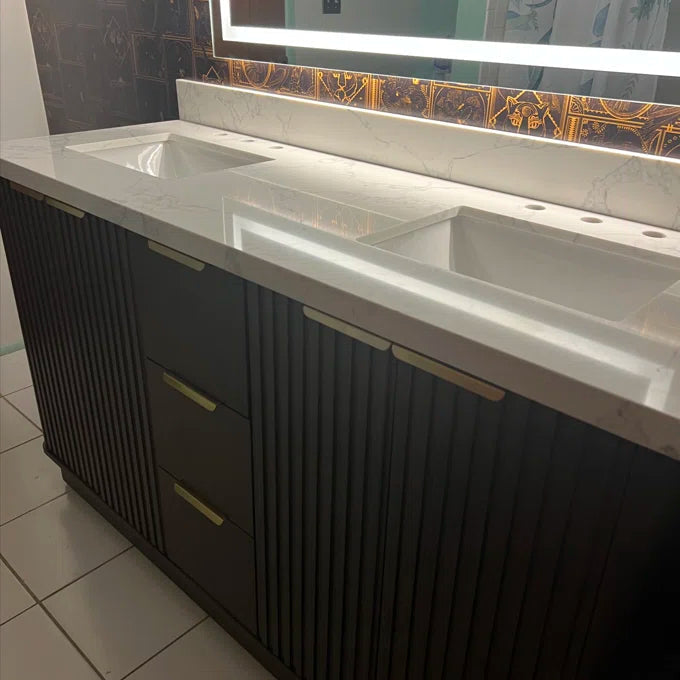 Bathroom vanity with marble countertop and dark cabinets