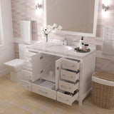Bathroom vanity with open drawers, sink, and decorative elements.